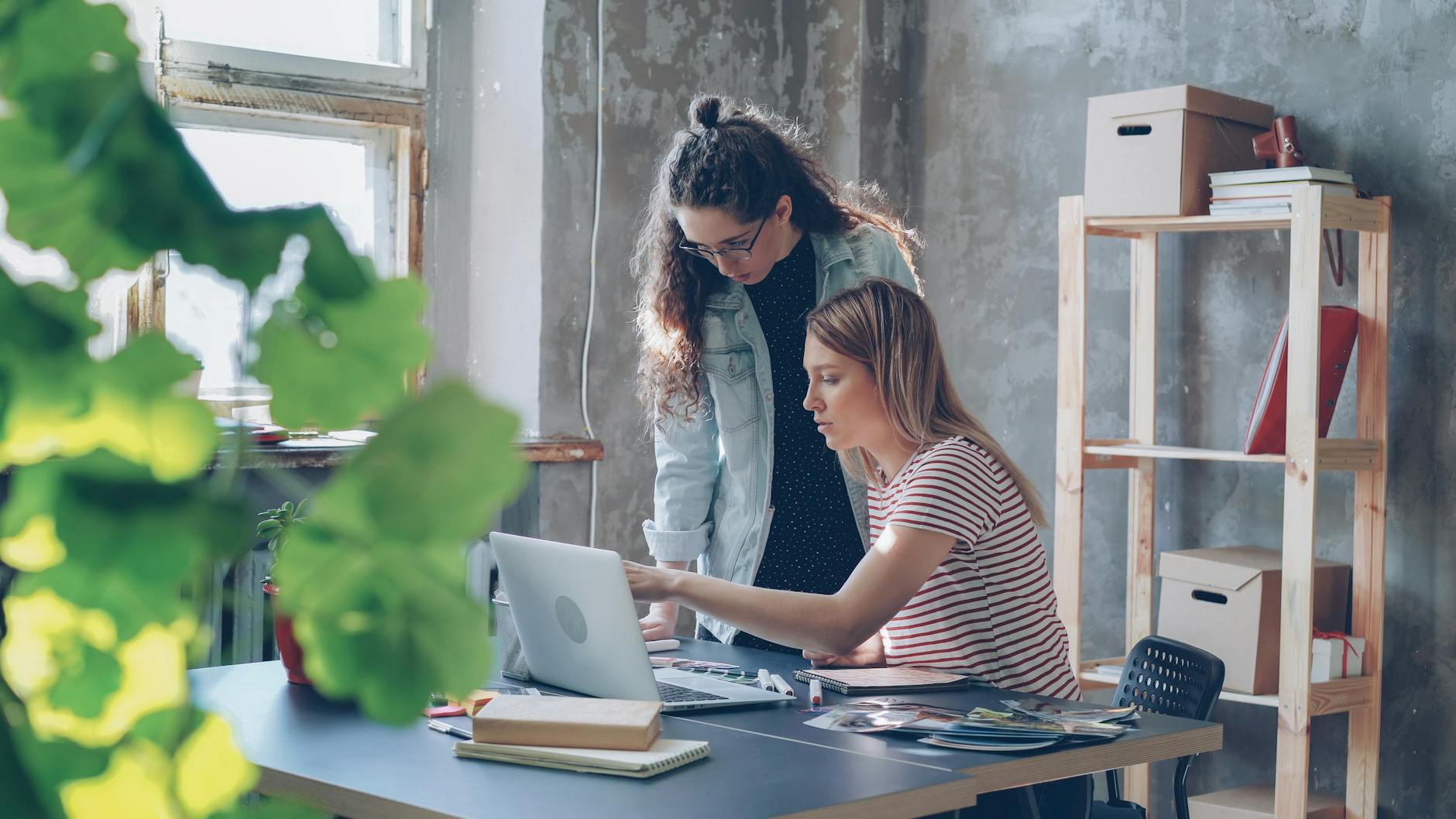 young women collaborating in stylish office